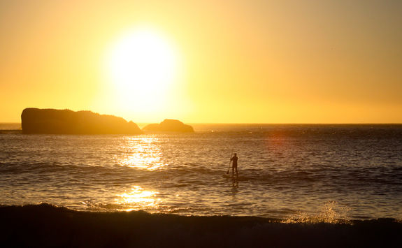 Paddle boarding on sunset