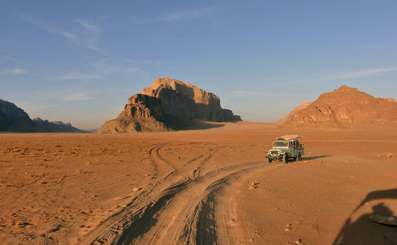 Car in Wadi Rum with Rock Formations