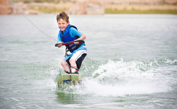 Child learning to wake-board