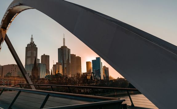Melbourne cityscape framed by walker pedestrian
