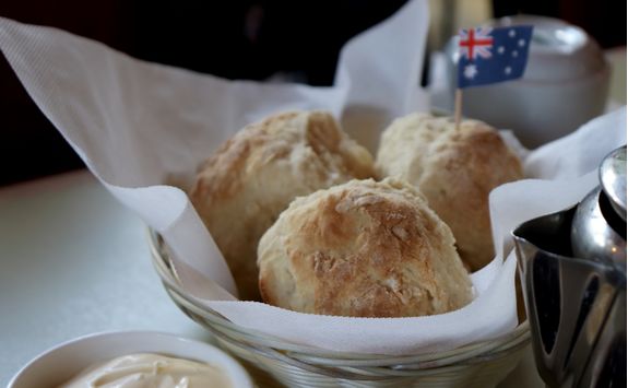 Scone with butter and jam and an Australian flag