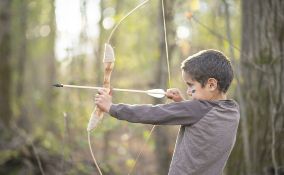 Young boy doing archery in British Columbia