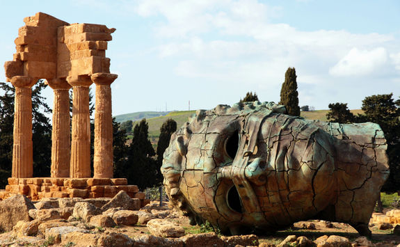 colossus head and greek temple
