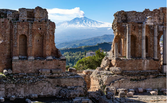 volcano ethna seen through ruins