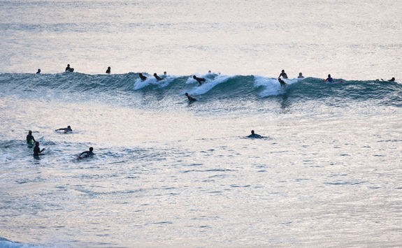 surfers at sunset