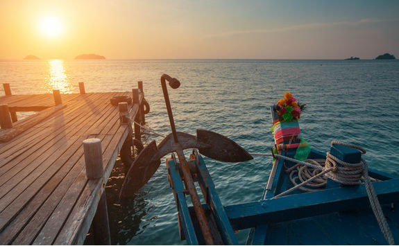 wooden fishing boat at sunset