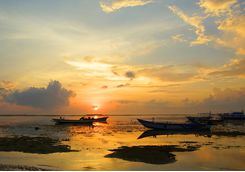 Boats in the ocean on Sanur beach
