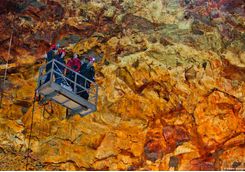 Family going down the lift into the volcano crater