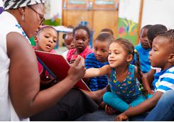 children and teacher in township