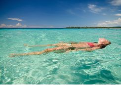 A woman relaxing in the ocean at Lombok beach