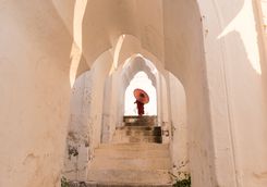 Mandalay Monk walking up white stairs