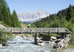 Mountain bike over bridge in Alps