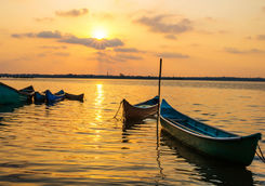 Small fishing boats at sunset