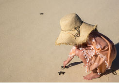 Little girl releasing a turtle on the beach