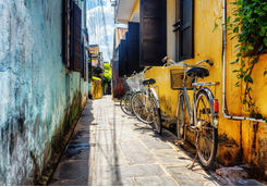 bicycles parked near yellow wall