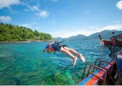 men diving off boat