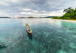 traditional canoe floating at sunset
