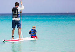 Paddleboarding father and son