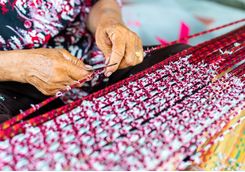 woman weaving ikat patern
