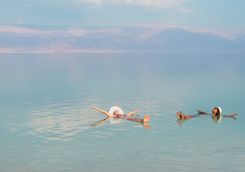 women floating in dead sea