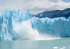 breaking ice falling from glacier