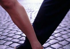 closeup of tango dancers foot step on pebble stone street