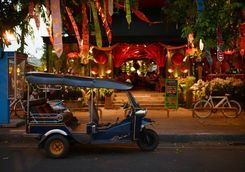 tuk tuk parked in front of a restaurant