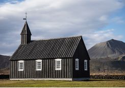 Black church with volcano at background