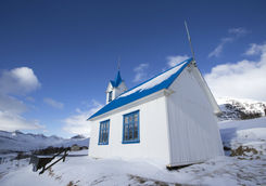 Blue church on Iceland in winter covered with snow