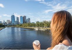 Woman on bridge overlooks Melbourne