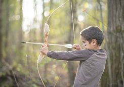 Young boy doing archery in British Columbia