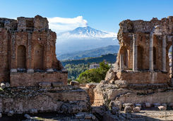 volcano ethna seen through ruins