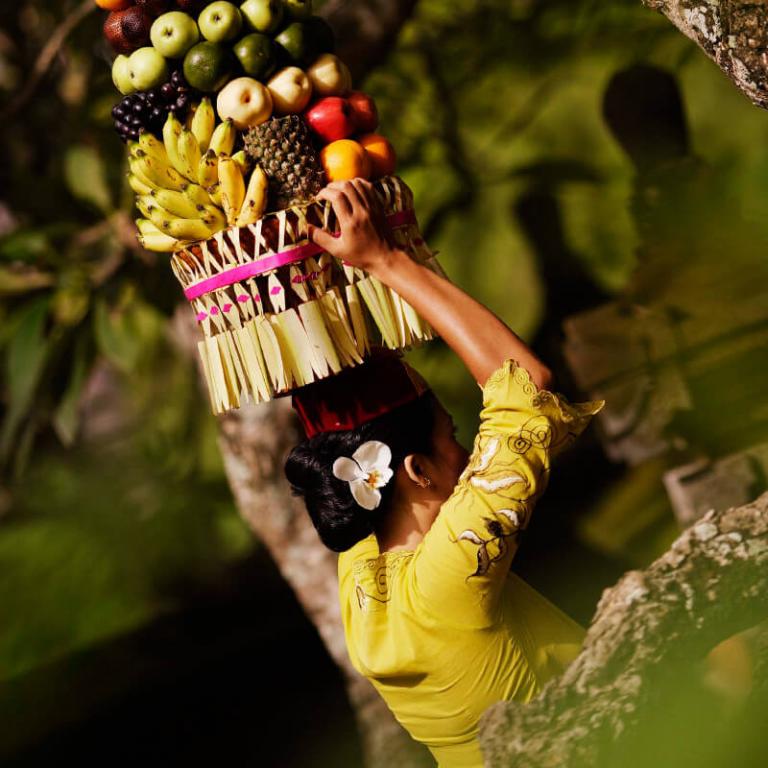 A lady holding flowers on her head