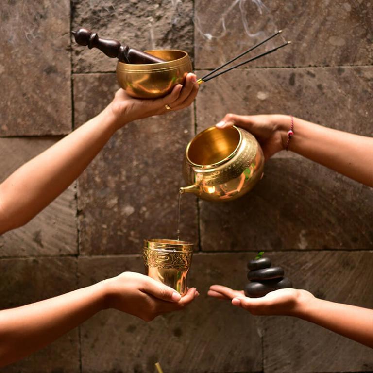 Hands holding gold cups