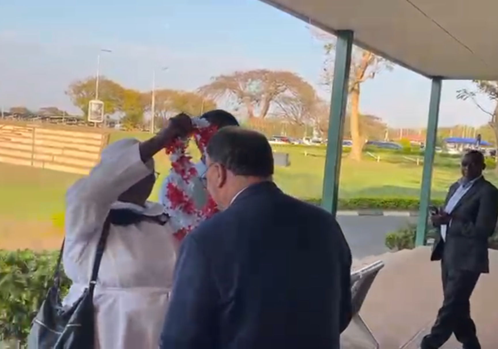 Moderator recieving a garland of flowers on arriving in Malawi