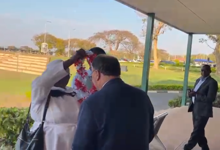 Moderator recieving a garland of flowers on arriving in Malawi