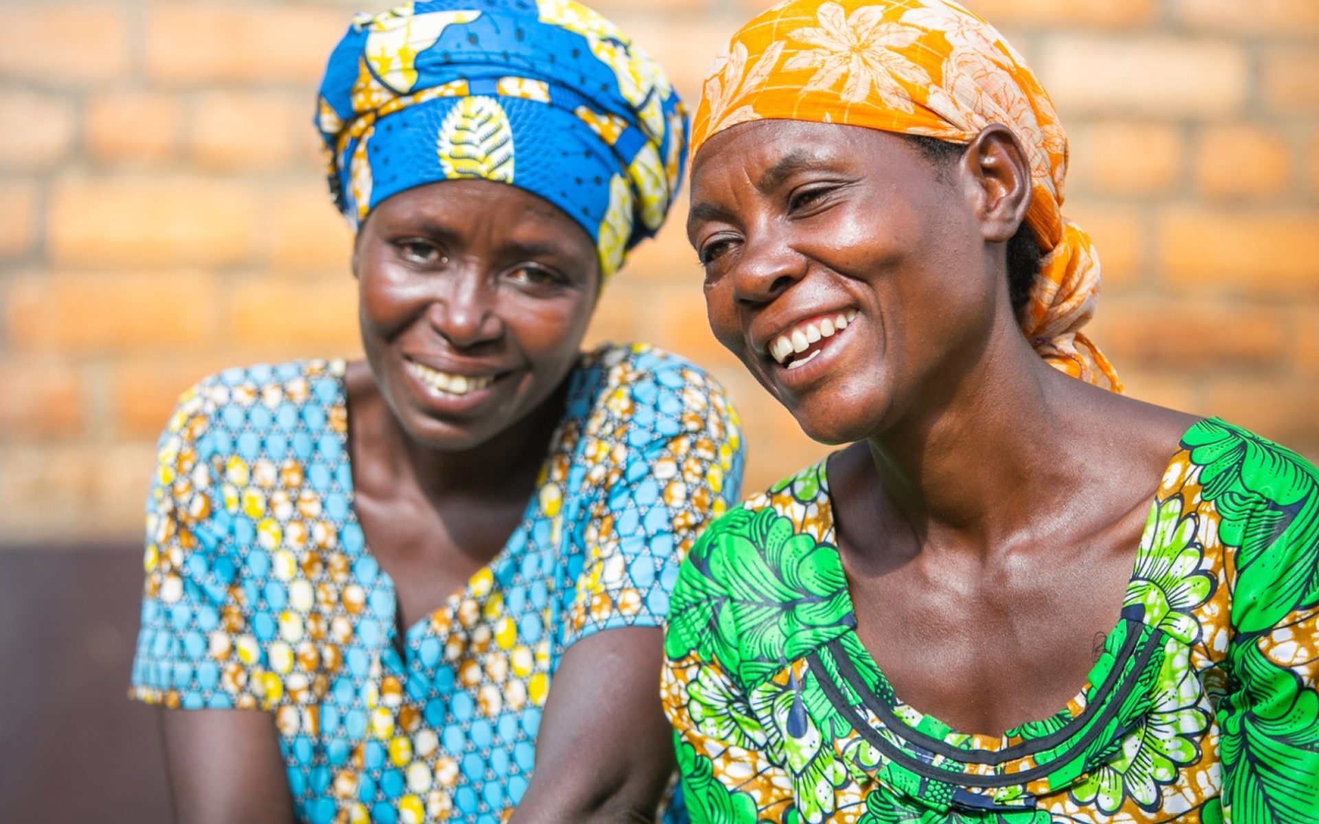 Two women smiling and laughing together hero