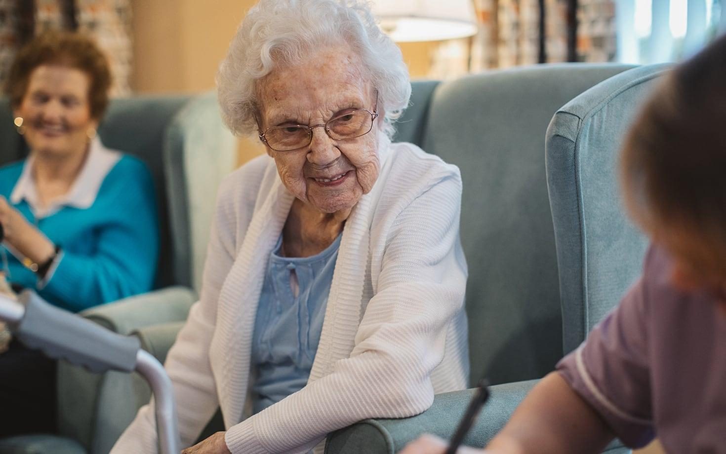 Elderly person sitting down talking