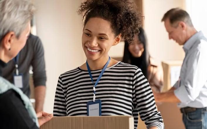 Person holding box talking to person