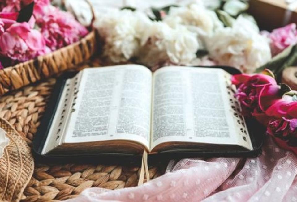 Bible opened surrounded by flowers