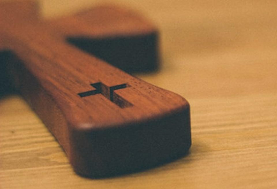 Cross on wooden table