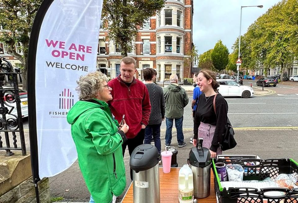 Group of people gathering outside drinks
