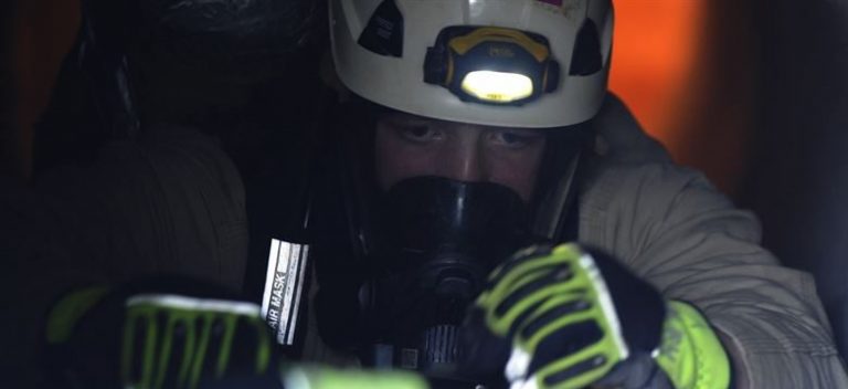 Worker in confined space with PPE.