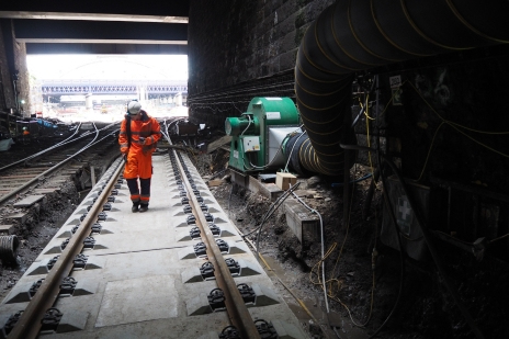 Rail engineer walking through tunnel being ventilated