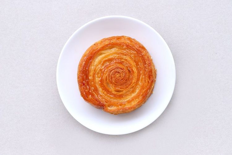 Kouign,Amann,Croissant,Served,On,Plate,Isolated,On,Light,Gray