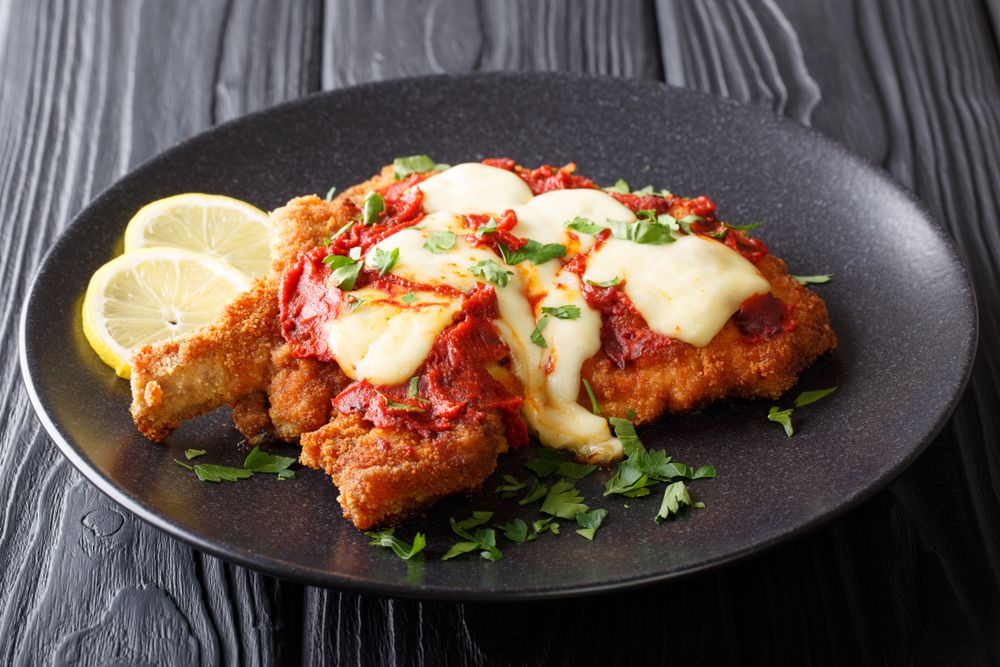 Delicious,Veal,Cutlet,With,Mozzarella,Cheese,,Lemon,And,Tomato,Sauce