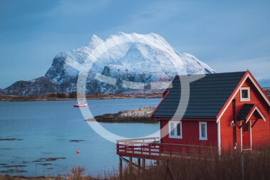 Naut and fishing boat with the Dønnamannen in the background