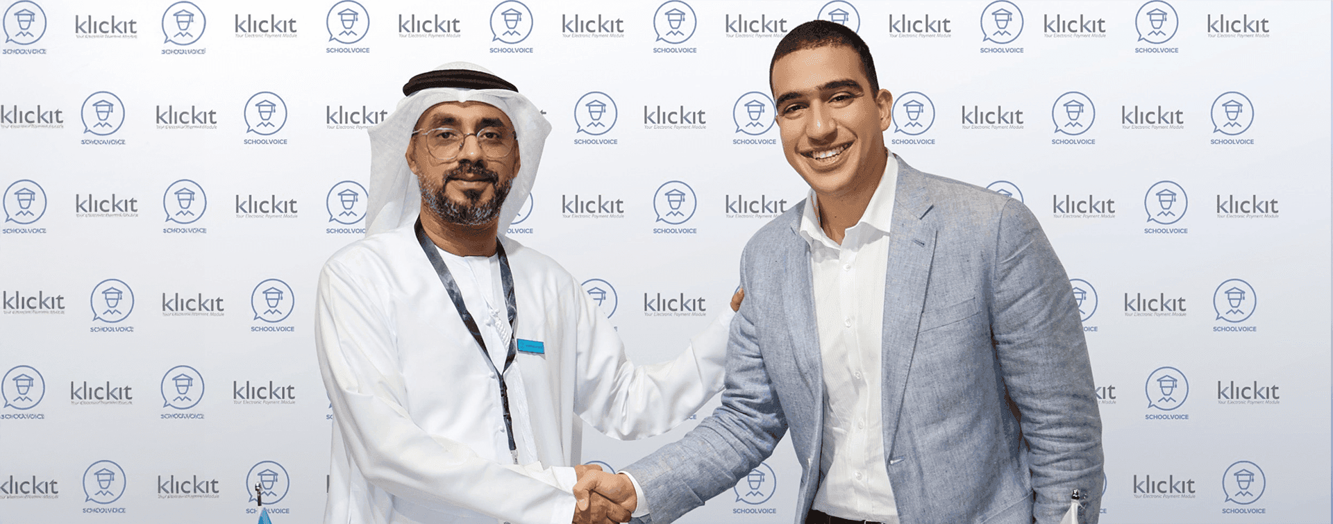 Ali bin Yahya shakes hands with Saeed Talaat, CEO and co-founder of the KlickIt platform, after signing a strategic partnership to integrate School Voice with school fees payment systems and unify financial and educational communication with parents.