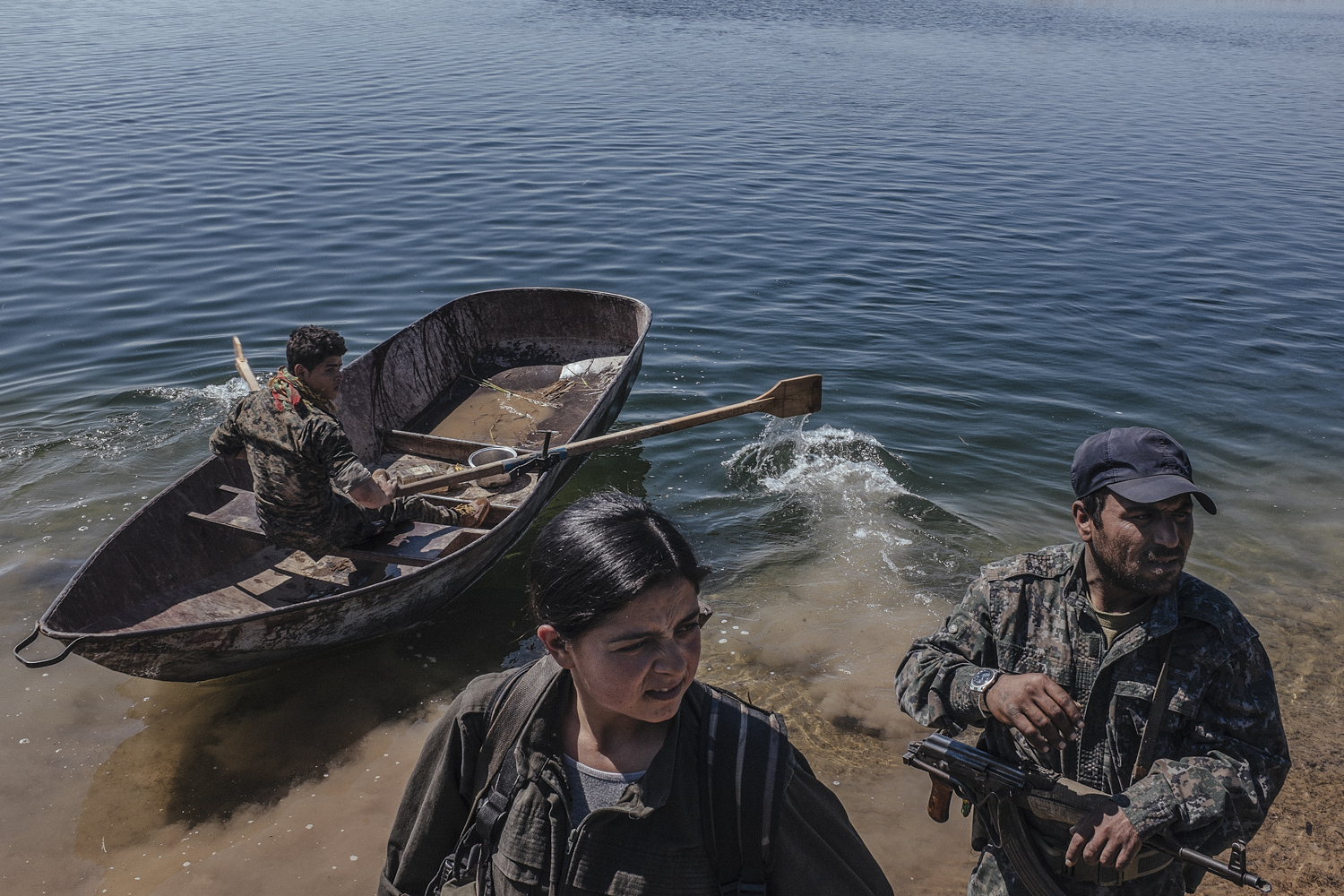 Des combattants kurdes en patrouille sur l'Euphrate, près de la ligne de front au sud de Kobané, Syrie, le 25 mars 2015.