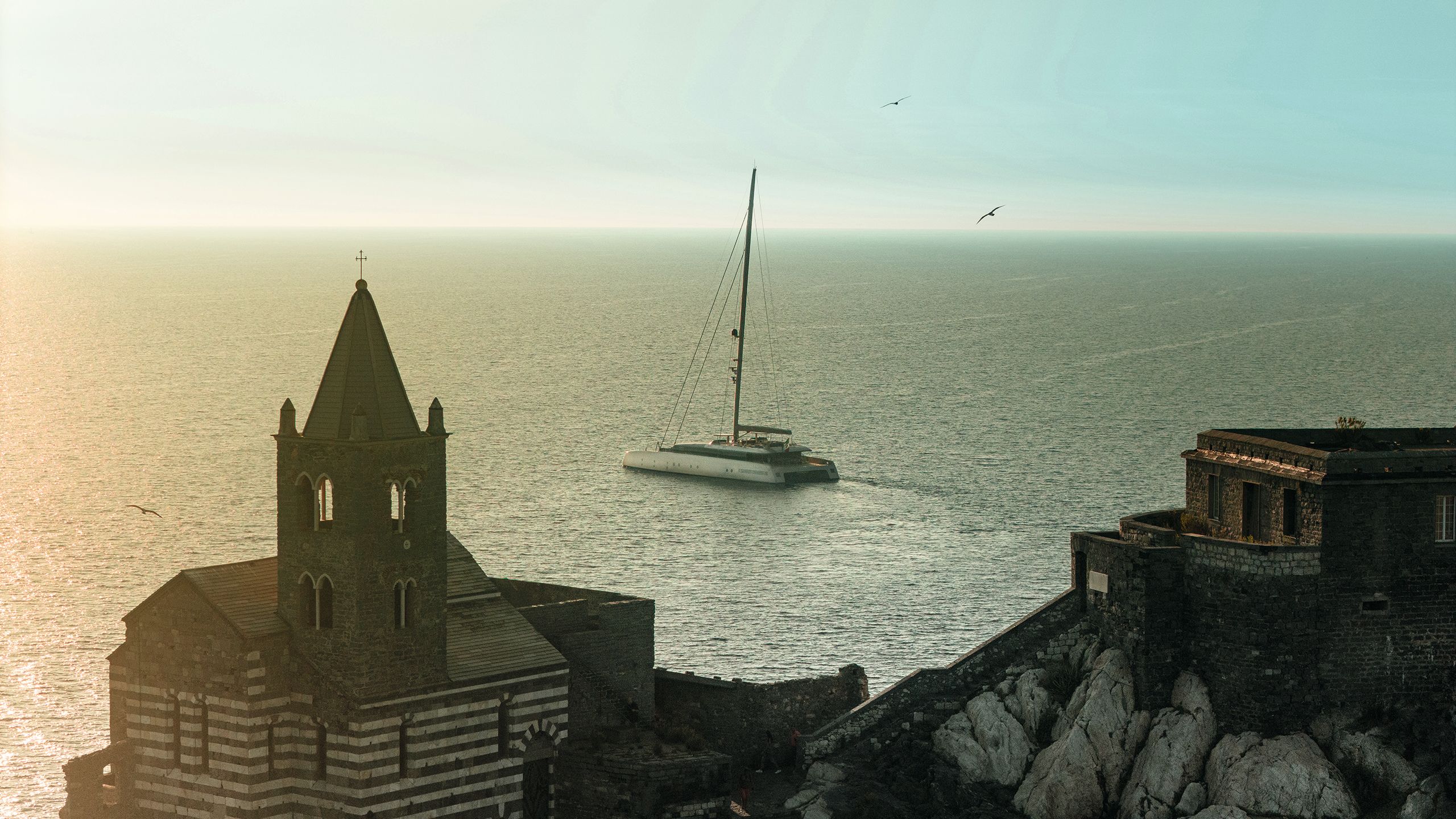 ArtExplorer on the sea from a distance with church in foreground